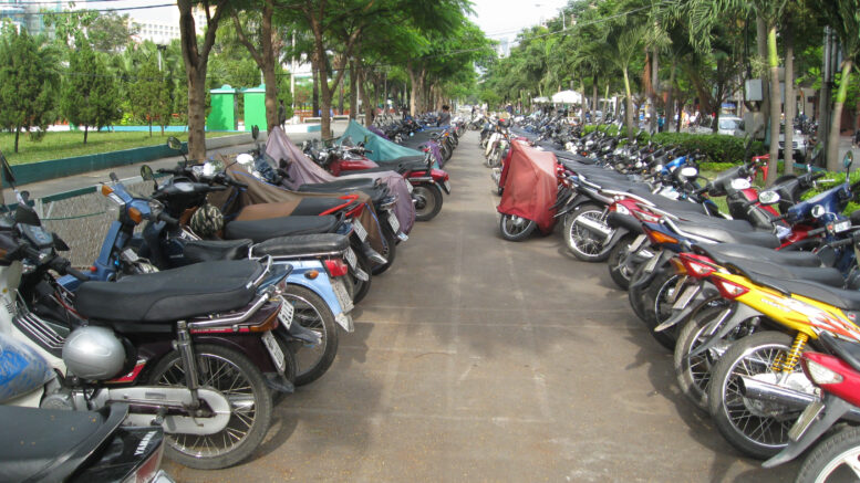 A large group of motorbikes parked in a street