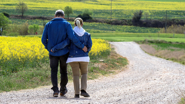 A couple walking in the countryside, arm in arm