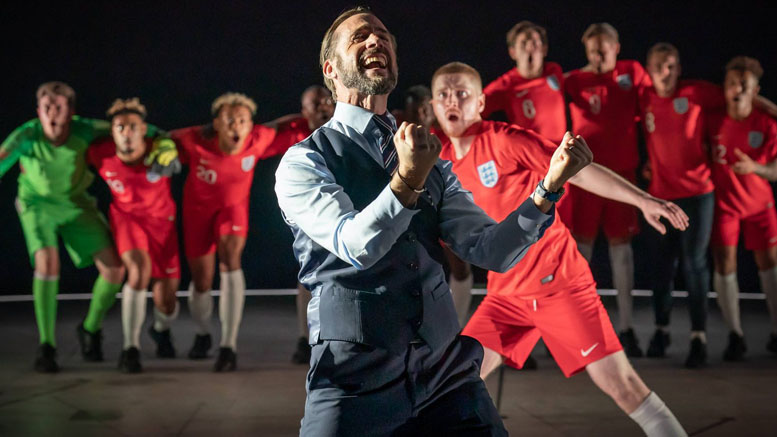 Joseph Fiennes as Gareth Southgate stands in front of cast members dressed as England footballers