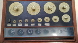 A wooden box of weights from the Victorian era