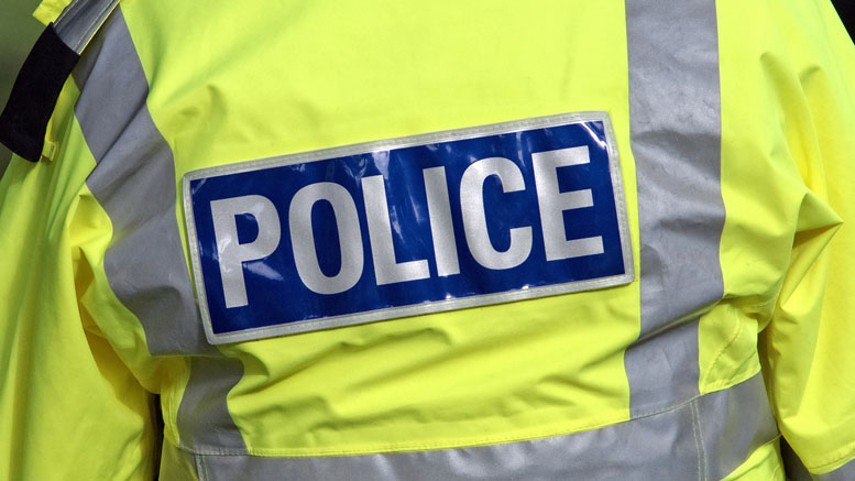 A close up of a police high vis yellow coat used as generic photo