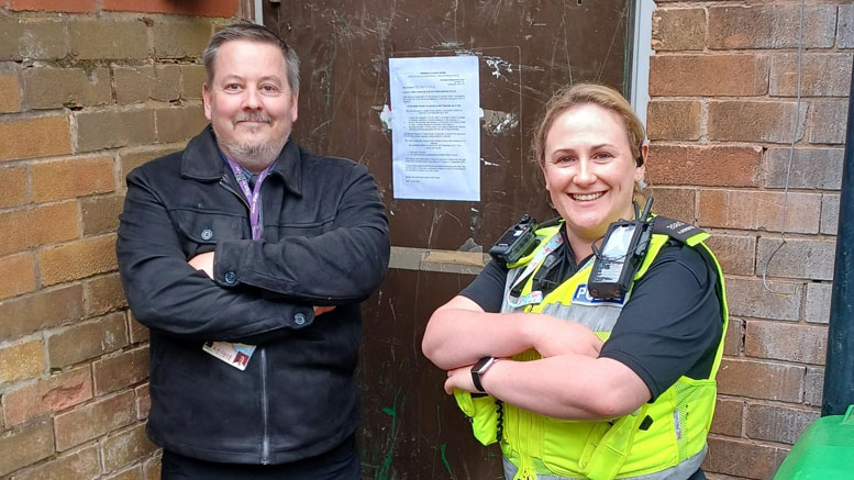 A council official and a police officer outside a house with a court notice pinned to the door