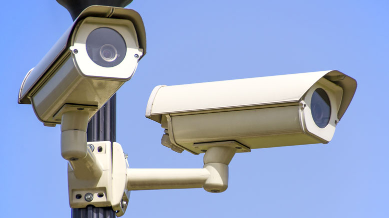 A close up of two CCTV cameras